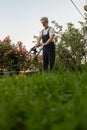 Older man mowing the lawn Royalty Free Stock Photo