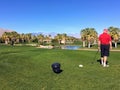 An older man playing golf standing on the tee box Royalty Free Stock Photo