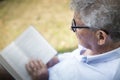 Older man reading outside Royalty Free Stock Photo