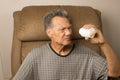 Man looking into his empty medicine bottle Royalty Free Stock Photo