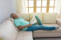 Older man sleeping on his couch at home. Sick grandpa resting in the living room. Health care / Health care concept Royalty Free Stock Photo