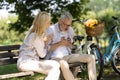 Older man suffering heart attack while sitting on bench in park Royalty Free Stock Photo