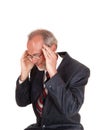 Older man in suit with headache.