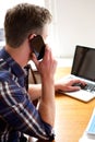 Older man talking on smart phone with laptop Royalty Free Stock Photo