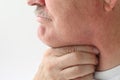 Older man with throat pain
