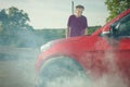 Older man on trip desperate od his car with smoking engine and breakdown Royalty Free Stock Photo