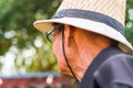 An older man wearing a white hat prepare to farm.