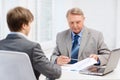 Older man and young man having meeting in office