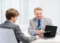 Older man and young man with laptop computer Royalty Free Stock Photo