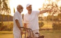Older men stand on a golf course and talk Royalty Free Stock Photo