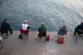 Older people sitting fishing