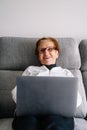 granmother using computer to conference with family during confinement by covid Royalty Free Stock Photo