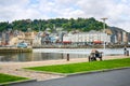 .An older retired couple sit on a park bench and enjoy the views of the fishing village of Honfleur France, in Normandy on a partl Royalty Free Stock Photo