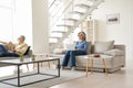 Older senior family couple spending time at home in modern living room. Royalty Free Stock Photo