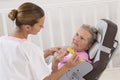 Older senior woman receiving home beauty treatment