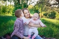 Older siblings, brother and sisters with little girl. Happy family picnic