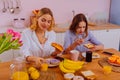 Older sister eating yummy croissant enjoying breakfast with sibling