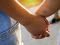 The older sister and sister hold hands walking together, Two children walking hand in hand. Royalty Free Stock Photo