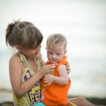 Older sister holds a beautiful girl with Down syndrome