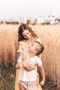 Older sister walks with her brother in nature in the summer. Happy kids sibling walking and playing. Kids play outdoors