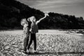 Older sister and younger brother, playing paper planes on ocean sea beach Royalty Free Stock Photo