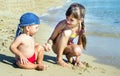 The older sister and younger brother on the seashore look at each other, Royalty Free Stock Photo