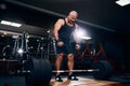 Older powerlifter preparing to exercise deadlift with barbell while on cross training in a gym. Royalty Free Stock Photo