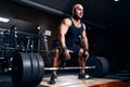 Older sportsman preparing to exercise deadlift with barbell while on cross training in a gym. Royalty Free Stock Photo