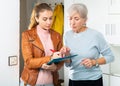 Older woman answering questions of female interviewer at home Royalty Free Stock Photo