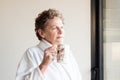 Older woman in bathrobe with cup of tea Royalty Free Stock Photo