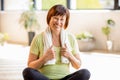 Older woman doing yoga indoors Royalty Free Stock Photo