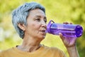 Older woman drinks water outdoors, closeup face view Royalty Free Stock Photo