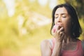 Older woman is eating apple after exercising to take care of the