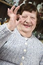 Older woman giving okay sign