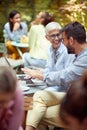 An older woman and her young male friend discussing an interesting laptop content while having a coffee in a bar. Leisure, bar, Royalty Free Stock Photo