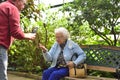 Older Woman holding a butterfly