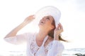 Older woman laughing with hat at the beach Royalty Free Stock Photo