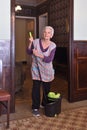 Older woman with mop making the floor of her house Royalty Free Stock Photo