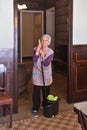 Older woman with mop making the floor of her house Royalty Free Stock Photo