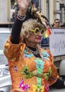 2019: A an older woman in an ornage costume attending the Gay Pride parade also known as Christopher Street Day CSD in Munich