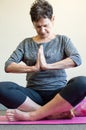 Older woman in prayer position