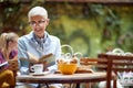 An older woman reading a book while having a coffee in the bar. Leisure, bar, outdoor Royalty Free Stock Photo