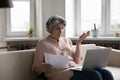 Older woman check utilities, experiences problems with payments looks concerned Royalty Free Stock Photo