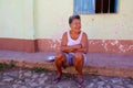 Older Woman Sitting on Curb in Trinidad, Cuba