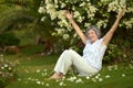 Older woman sitting with flowers Royalty Free Stock Photo