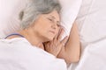 Older woman sleeping in the bedroom