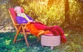 Older woman sleeping in chair in the garden Royalty Free Stock Photo
