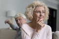 Older woman suffers from resentment after quarrel with angry husband Royalty Free Stock Photo