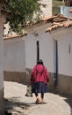 An older woman walking the streets