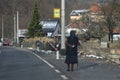 older woman walks down the street